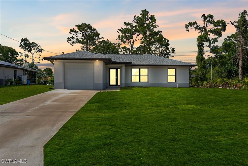 Prairie-style home with stucco siding, a garage, a