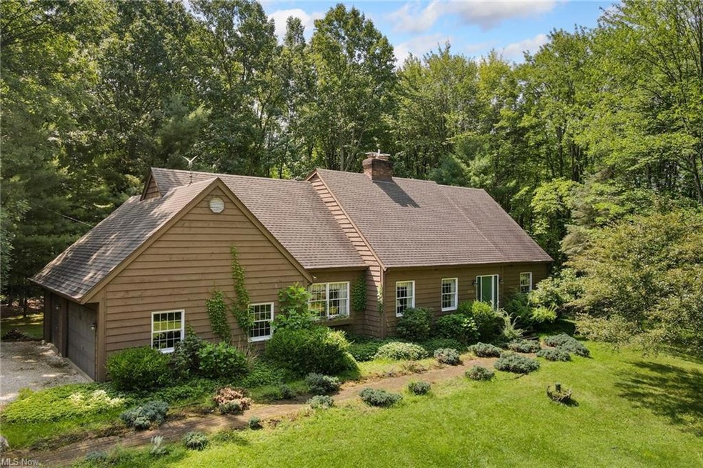 View of front of home with garage and a front yard