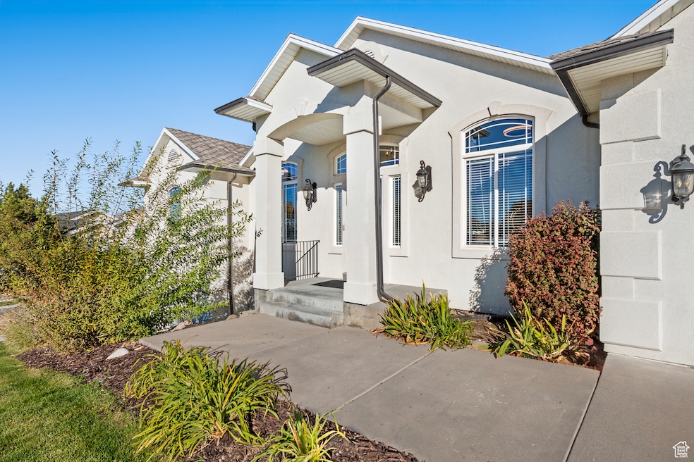 View of exterior entry featuring stucco siding
