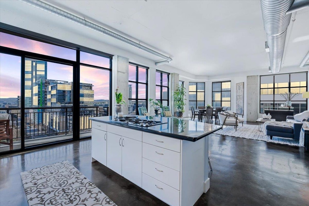 Kitchen with finished concrete floors, white cabi