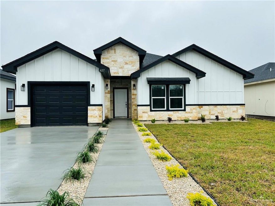 Modern farmhouse featuring a front lawn and a garage