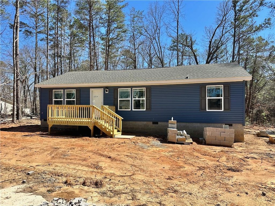 View of front of home with a shingled roof and cra