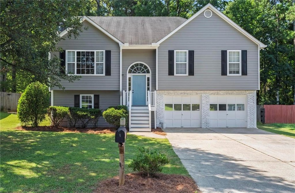 Split foyer home with a front yard and a garage