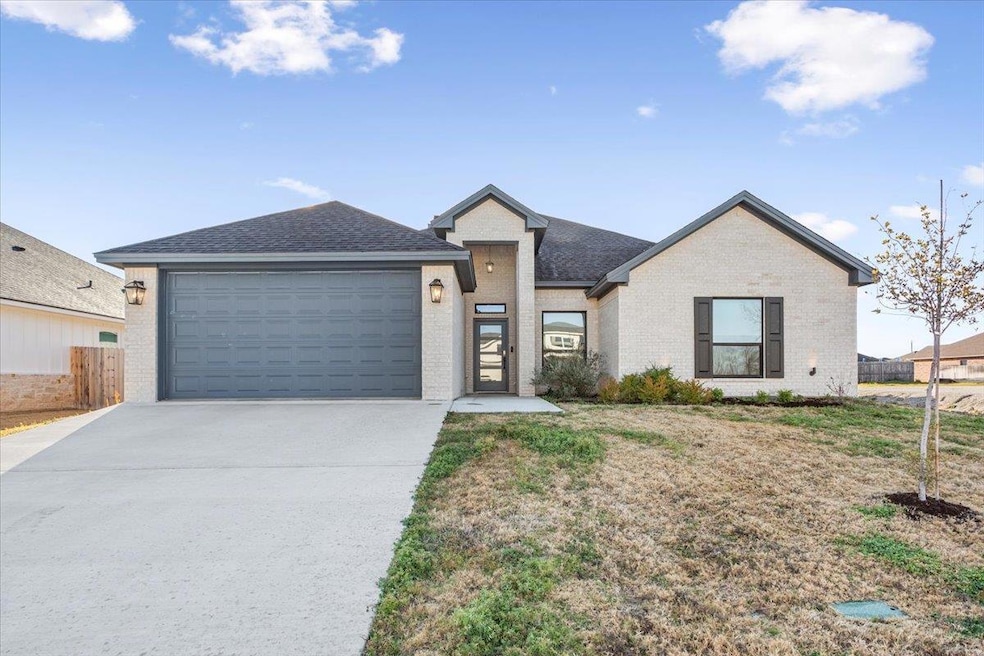 View of front of property with brick siding, conc