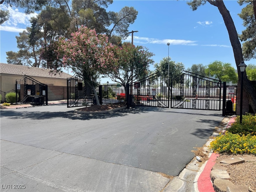 View of asphalt street with a gate, curbs, street