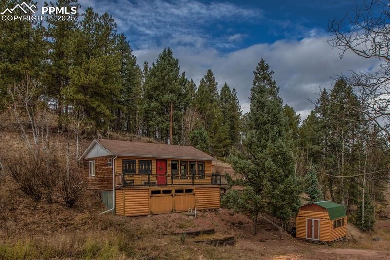 View of shed with a forest view