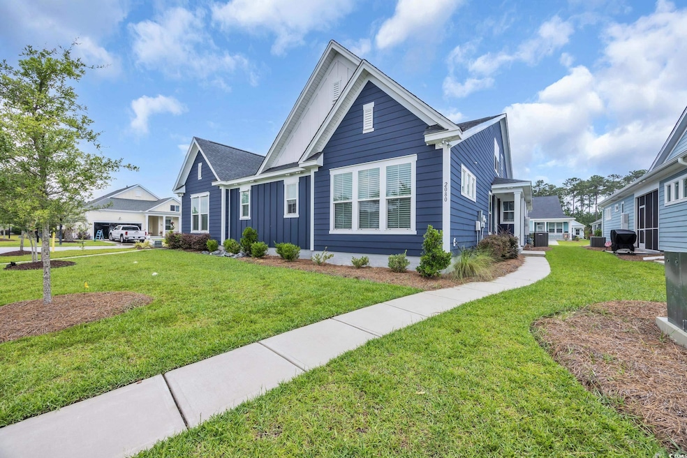 View of front of home with board and batten siding and a front yard