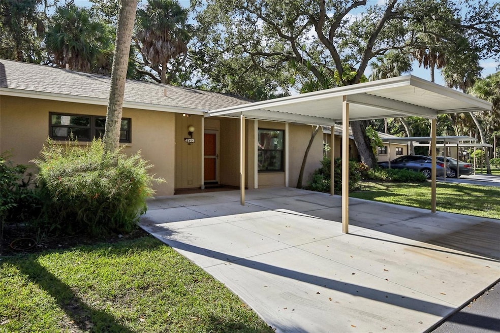 Front view with two parking spaces / one with carport.