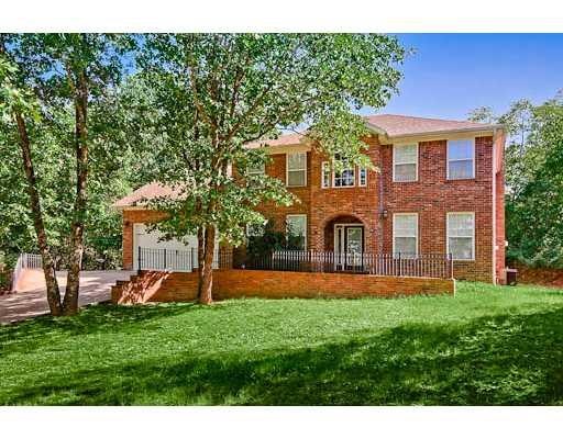 Exterior Front. Great curb appeal with large front yard and forested backyard with room for a pool