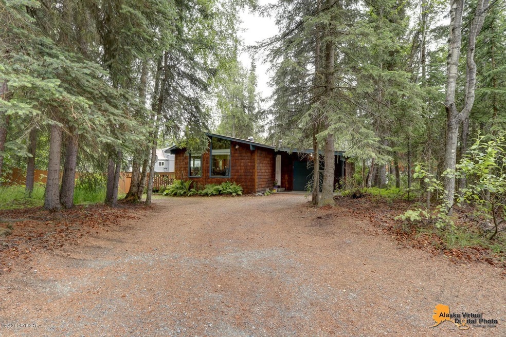 Tucked in wooded lot