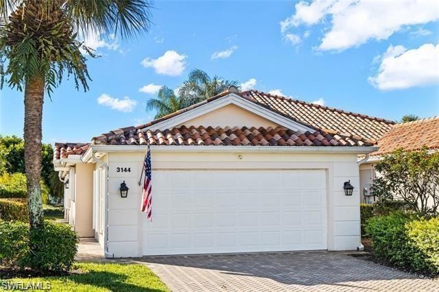 View of front of home featuring driveway, a garage