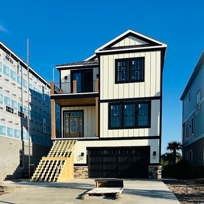 View of front of home with stone siding, concrete 