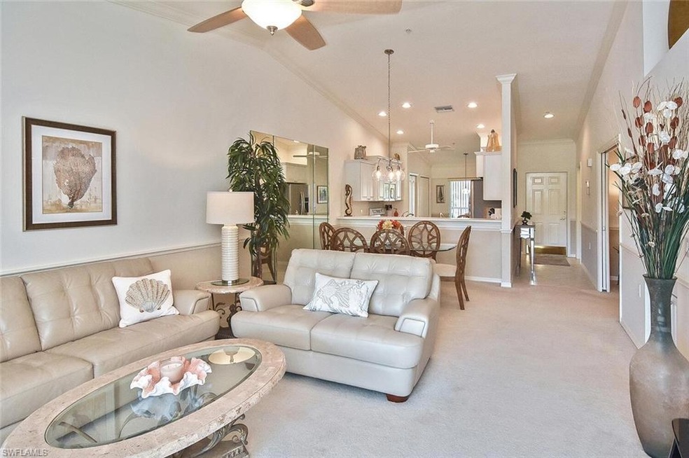 Living room with ceiling fan, ornamental molding, 