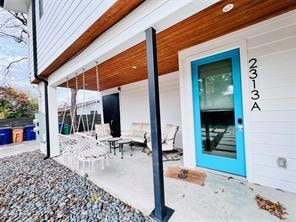 Doorway to property with a patio area