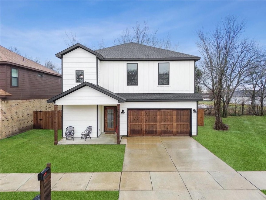 Modern inspired farmhouse featuring a garage and a