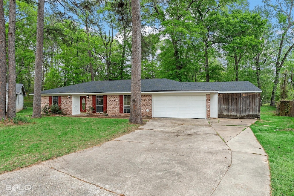Ranch-style house featuring a front yard, an attac