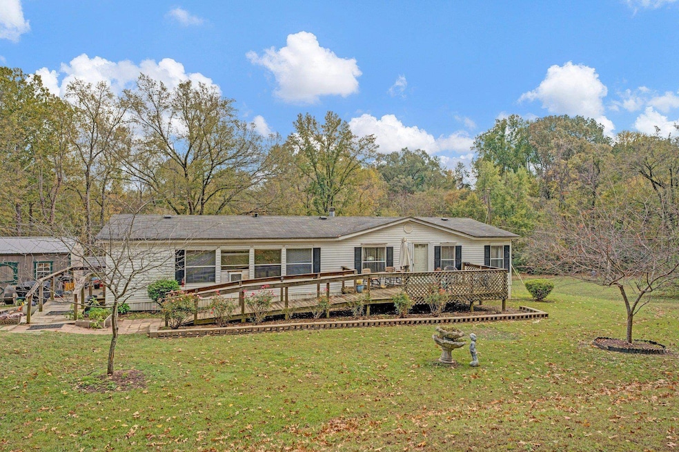 Ranch-style house featuring a front lawn and a woo