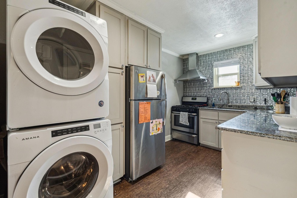 Kitchen featuring a sink, dark wood-style flooring