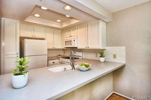 Remodeled kitchen with quartz slab counters, reces