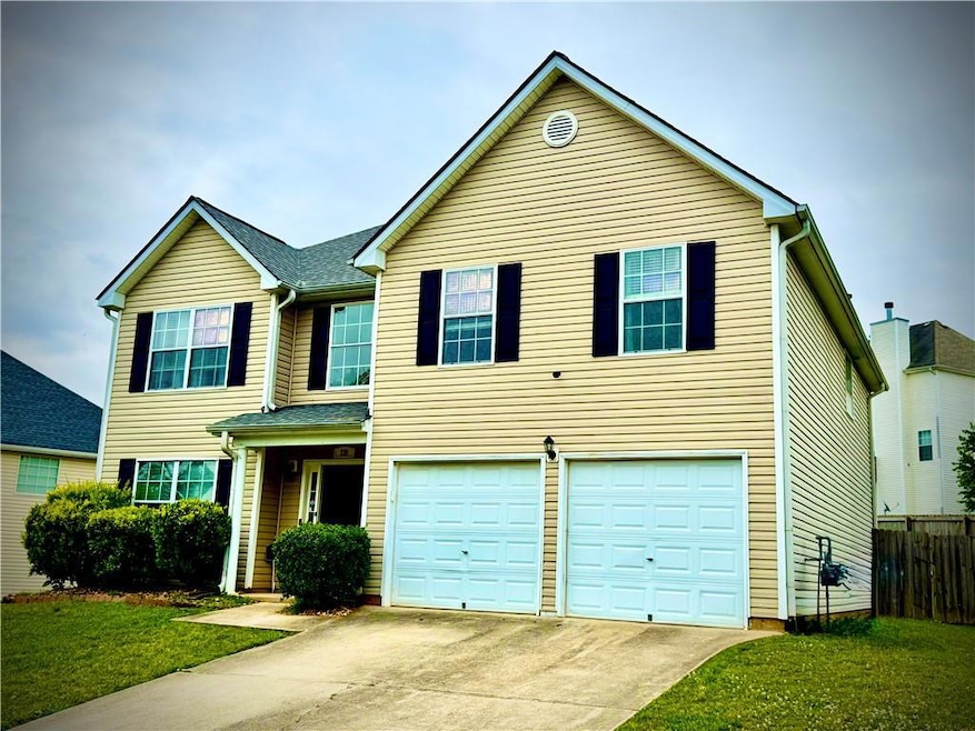 Traditional home featuring driveway, an attached g