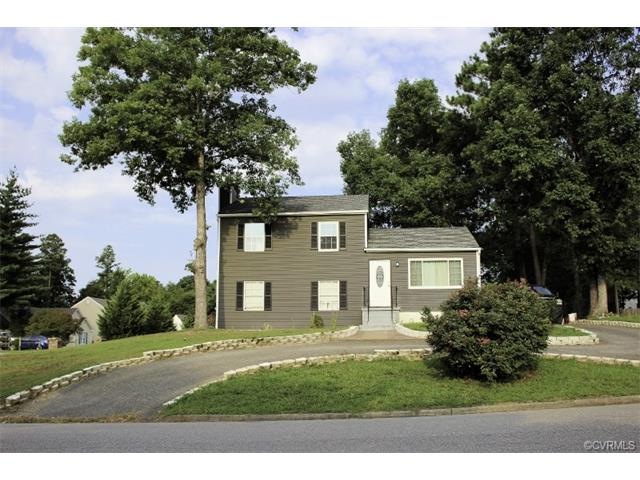 Front of house with circular paved drive