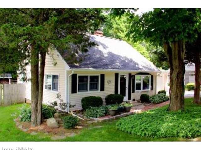 Exterior Front. Fully dormered Cape with vinyl sid