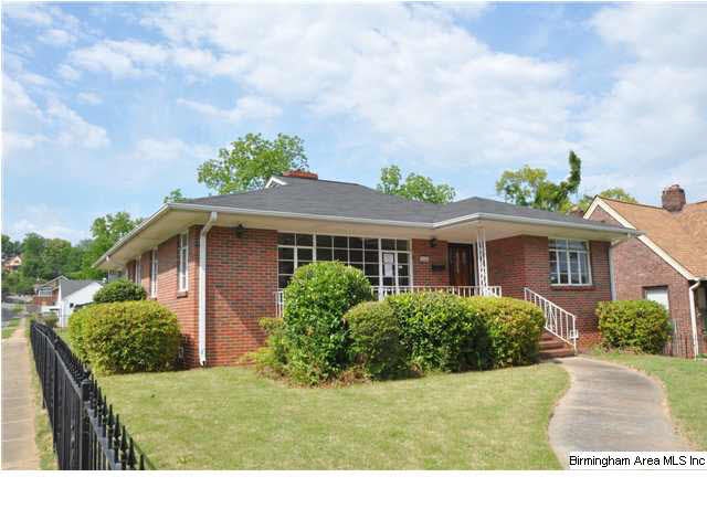 Corner lot with iron fence surrounding home