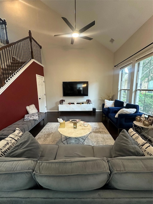 Living area featuring ceiling fan, wood finished 