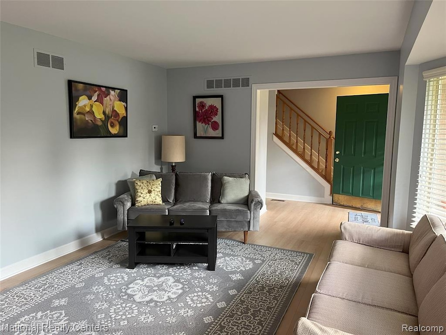 Living area featuring wood finished floors and stairs