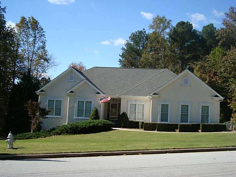 Exterior Front. Hardcoat stucco ranch with full un