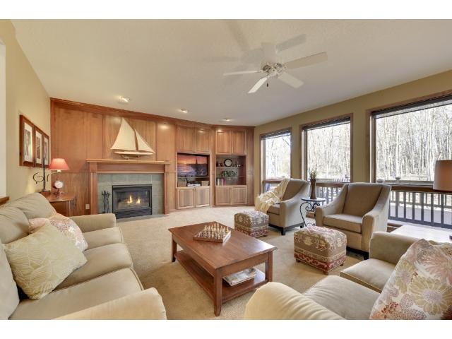 A spacious family room has floor-to-ceiling window