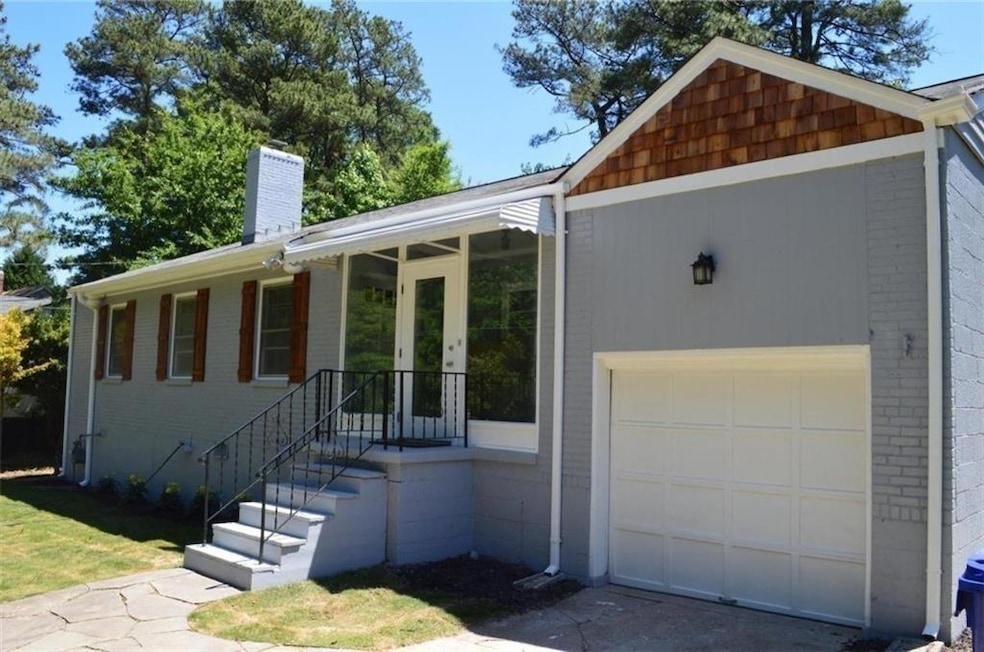Single story home with brick siding, a chimney, an