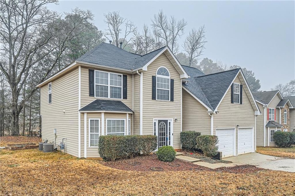View of front property featuring a garage and cent