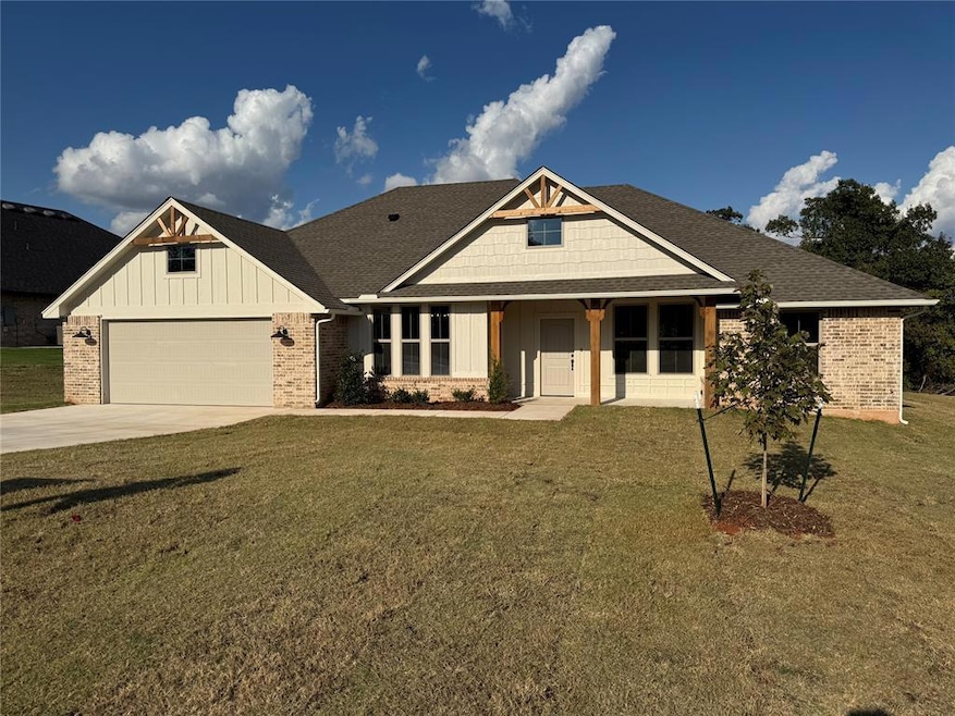 Craftsman-style home featuring board and batten siding, roof with shingles, covered porch, a front yard, and driveway