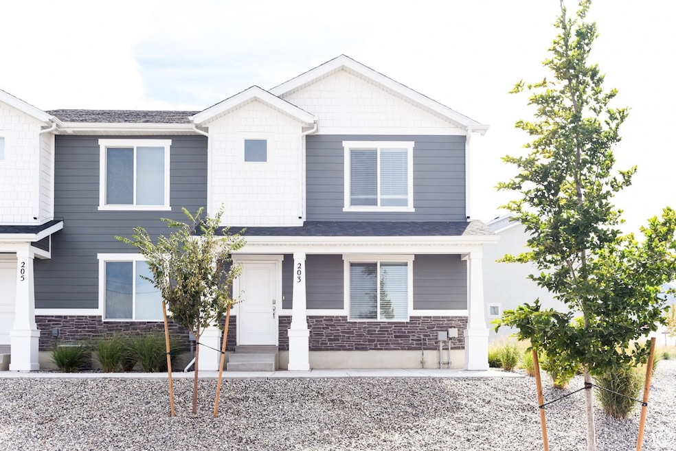 Craftsman house featuring stone siding and covered porch