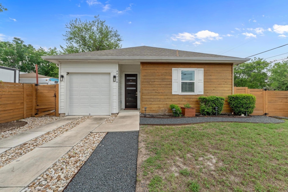 View of front of house with fence, concrete drive