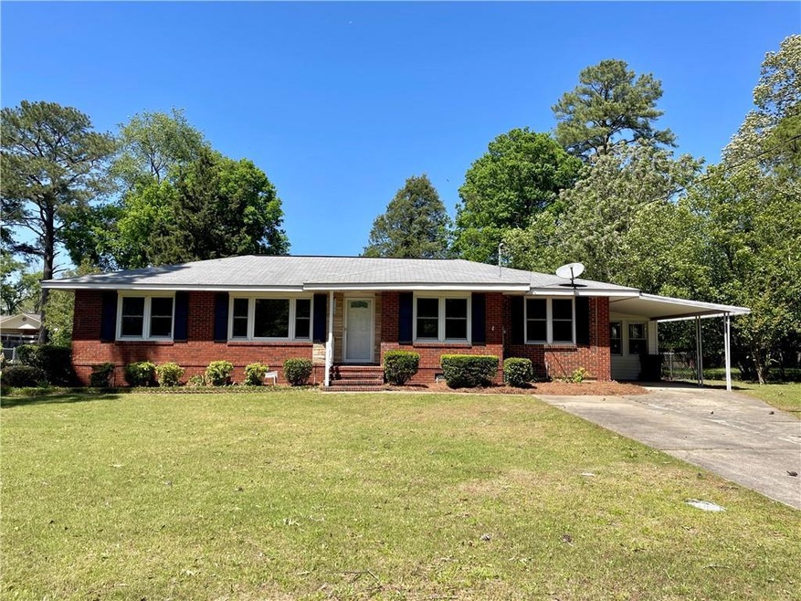 Single story home featuring a carport and a front 