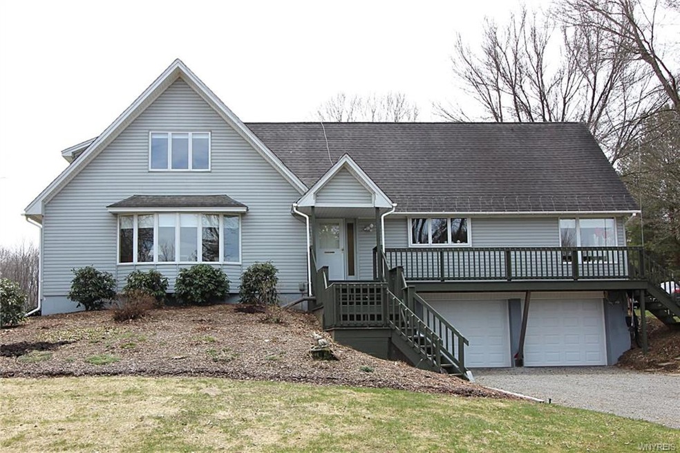 Great curb appeal with perennial gardens and a bea