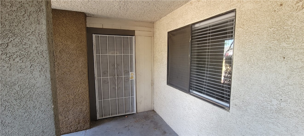 Entrance to property with stucco siding