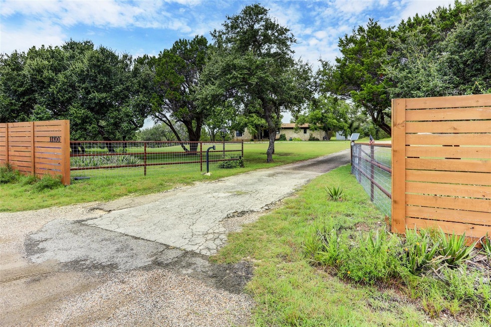 View of street featuring a gated entry, a gate, a