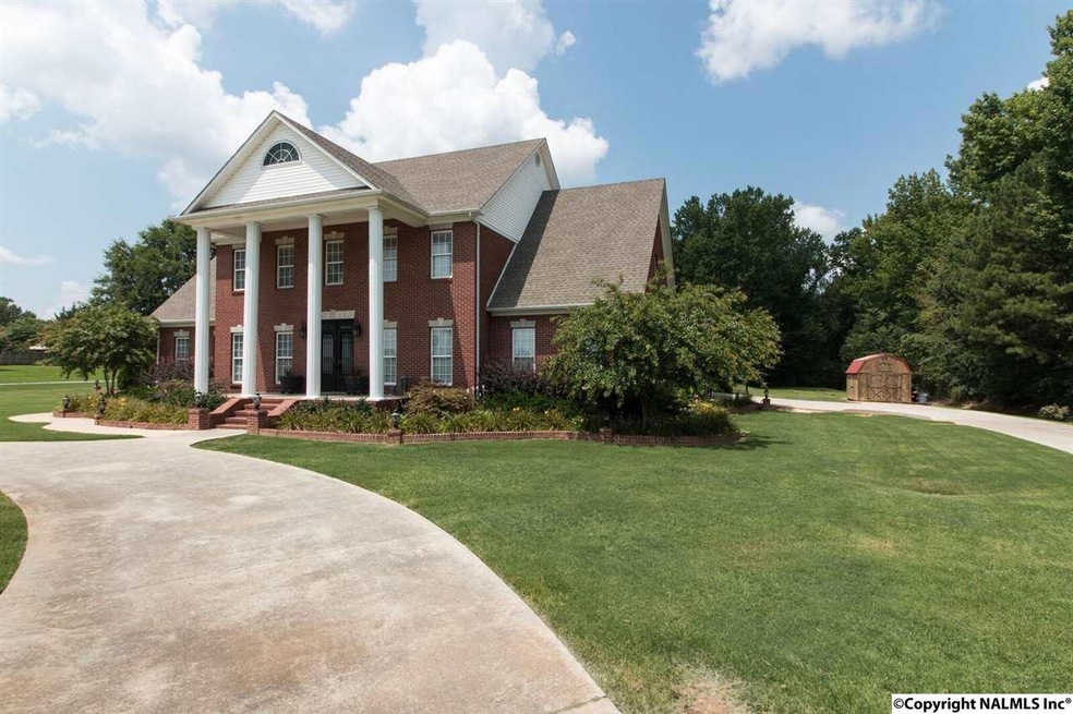 This home features a Beautiful Front View with  Iron and Brick Fence to accent the front of home with a concrete circle driveway.  This homes has all the features of country limits in the city limits of Athens.