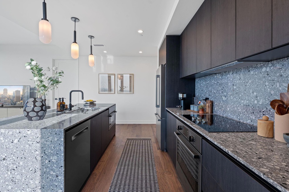 Kitchen with black appliances, a center island wi