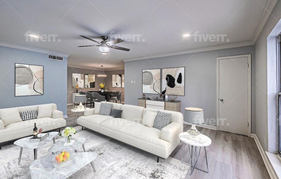 Living room featuring crown molding, ceiling fan, 