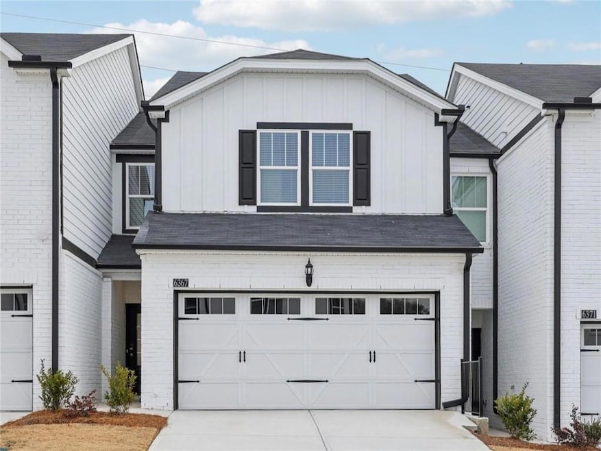 View of front of house with a garage, concrete dri