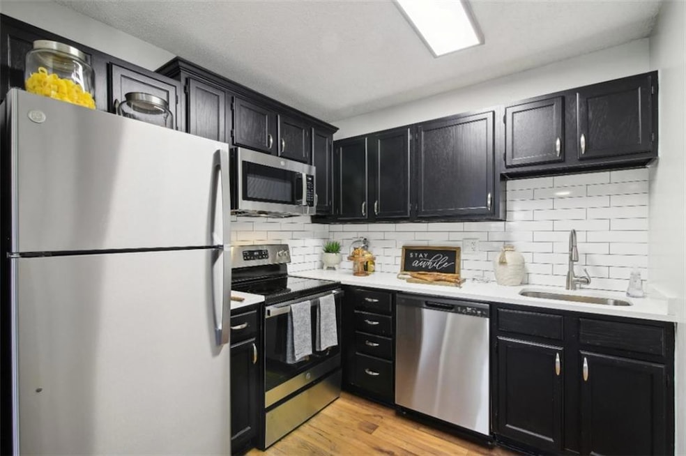 Kitchen with appliances with stainless steel finis