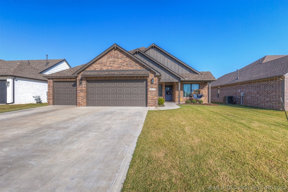 Front of house, 3 car garage with extended drivewa
