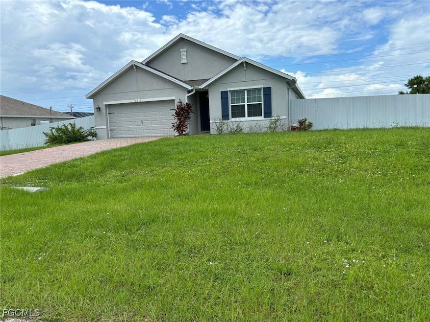 Ranch-style house featuring decorative driveway, stucco siding, and an attached garage