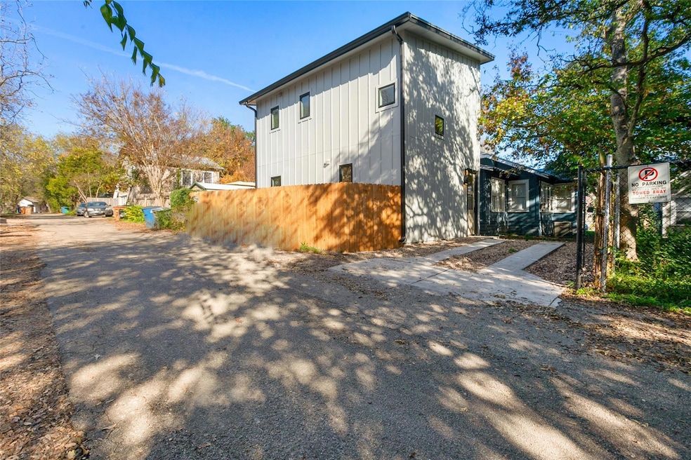 View of property exterior with driveway and board