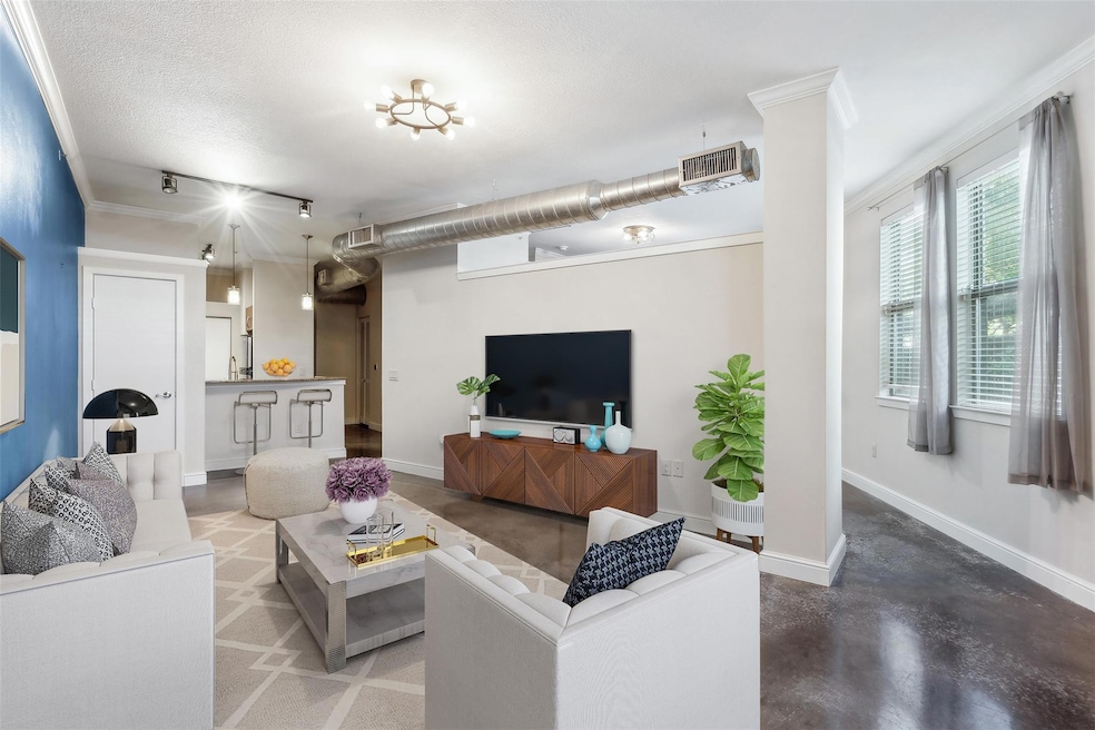 Living room with concrete floors, ornamental moldi