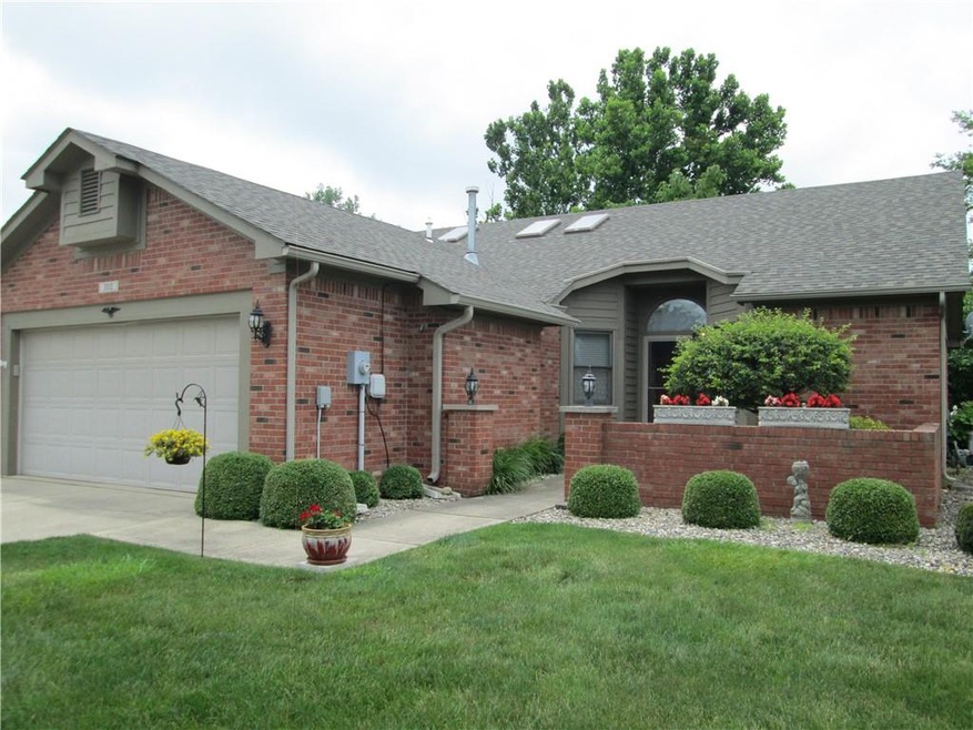 Brick condo with courtyard entry and two car attached garage